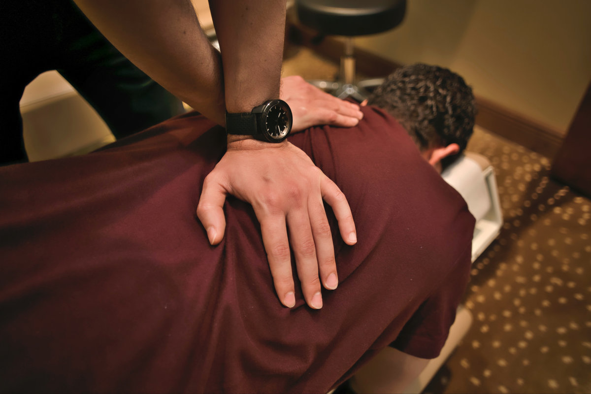 Person managing chronic pain with chiropractic support