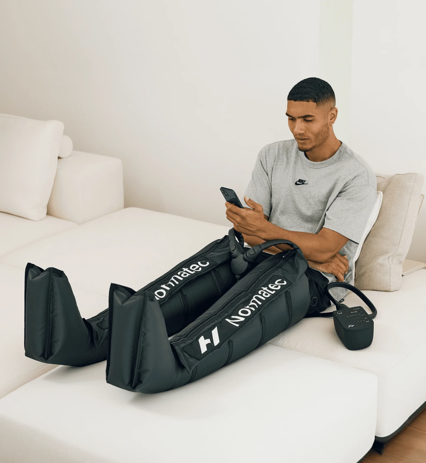 Patient relaxing with Normatec 3 compression boots on both legs